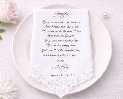 Handkerchief with a personalized message on a white plate, surrounded by flowers.