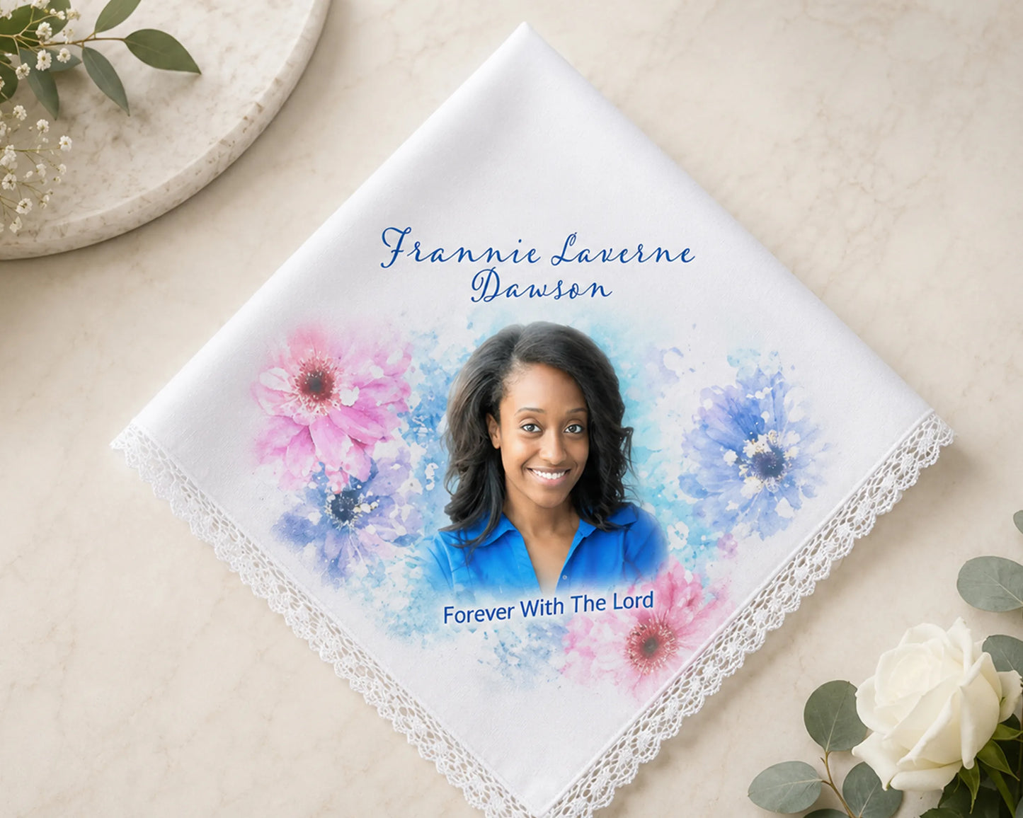 Handkerchief with a portrait of a woman and floral design on a beige surface.