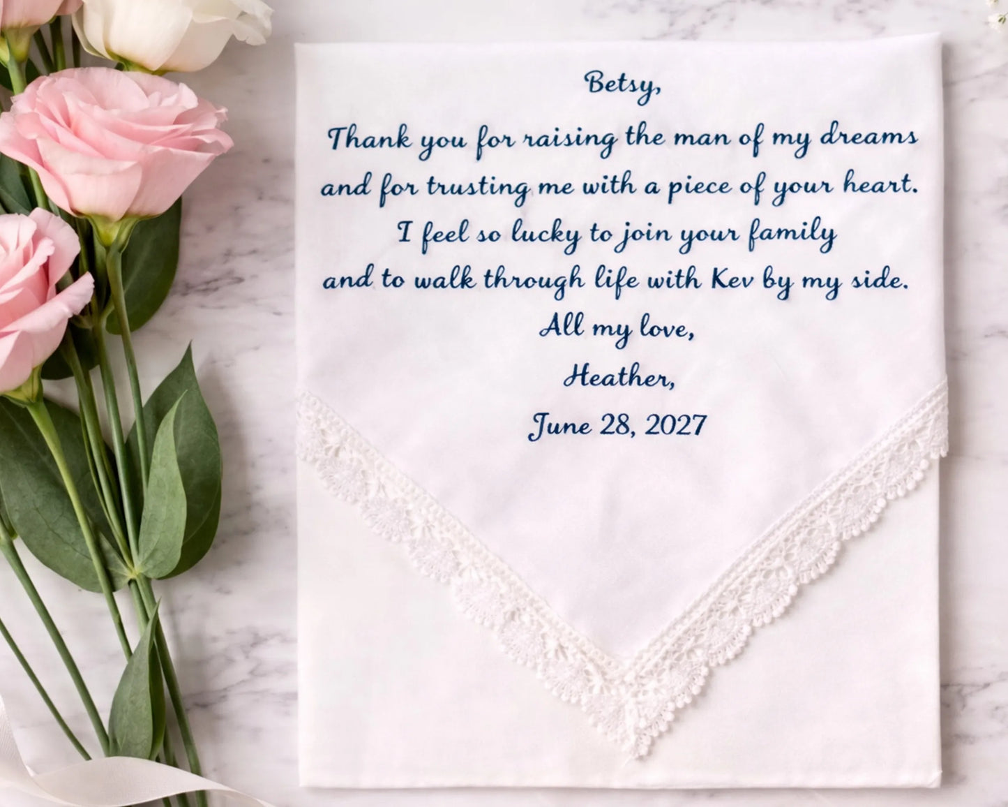 Hankie with embroidered message and pink roses on a marble surface
