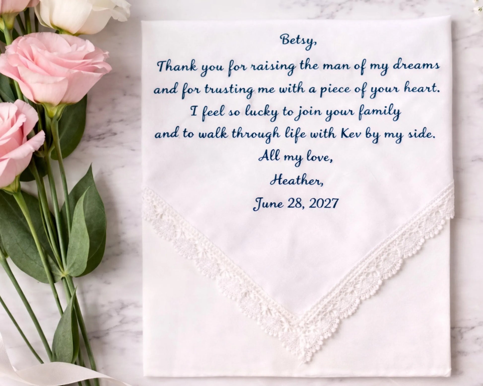Hankie with embroidered message and pink roses on a marble surface