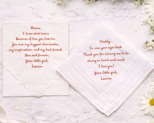 Hankie with heartfelt message to parents on a marble surface with flowers.