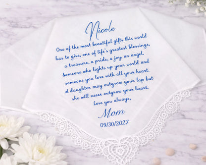 Hanky with personalized message from 'Mom' to 'Nicole' on a marble surface with flowers.