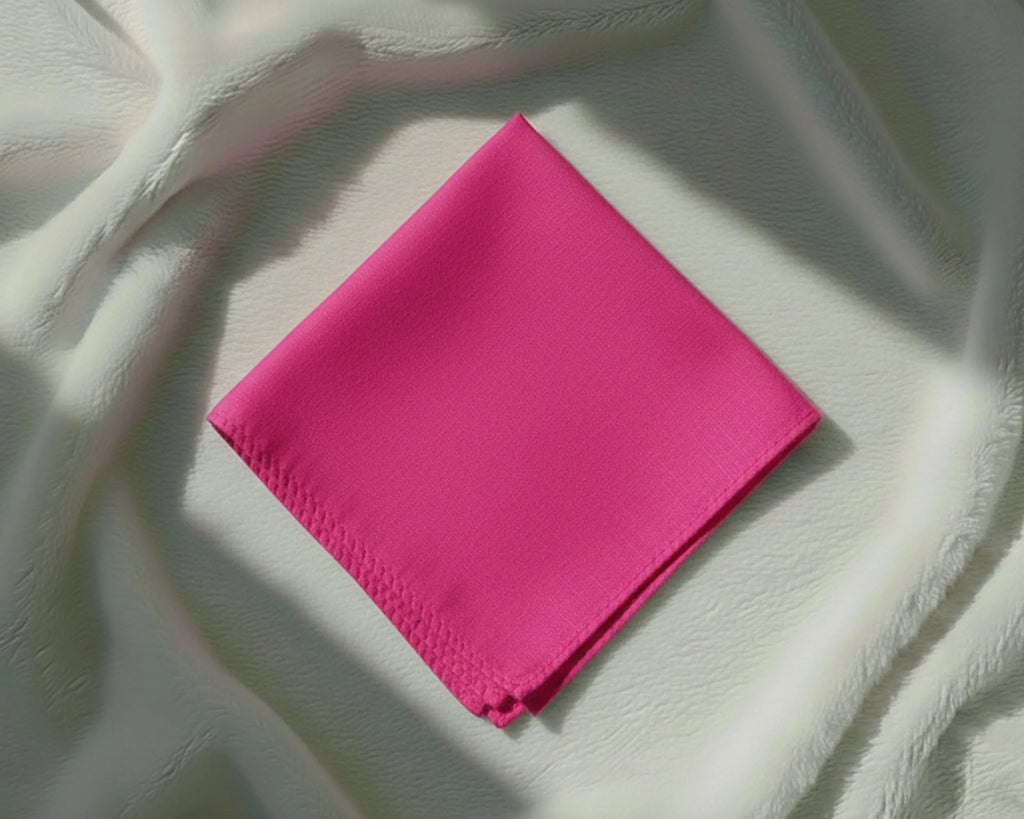 Pink fabric square on a textured white background