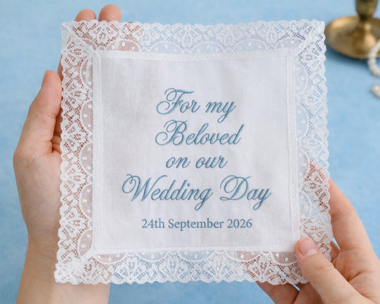 Lace handkerchief with personalized text held by hands against a blue background