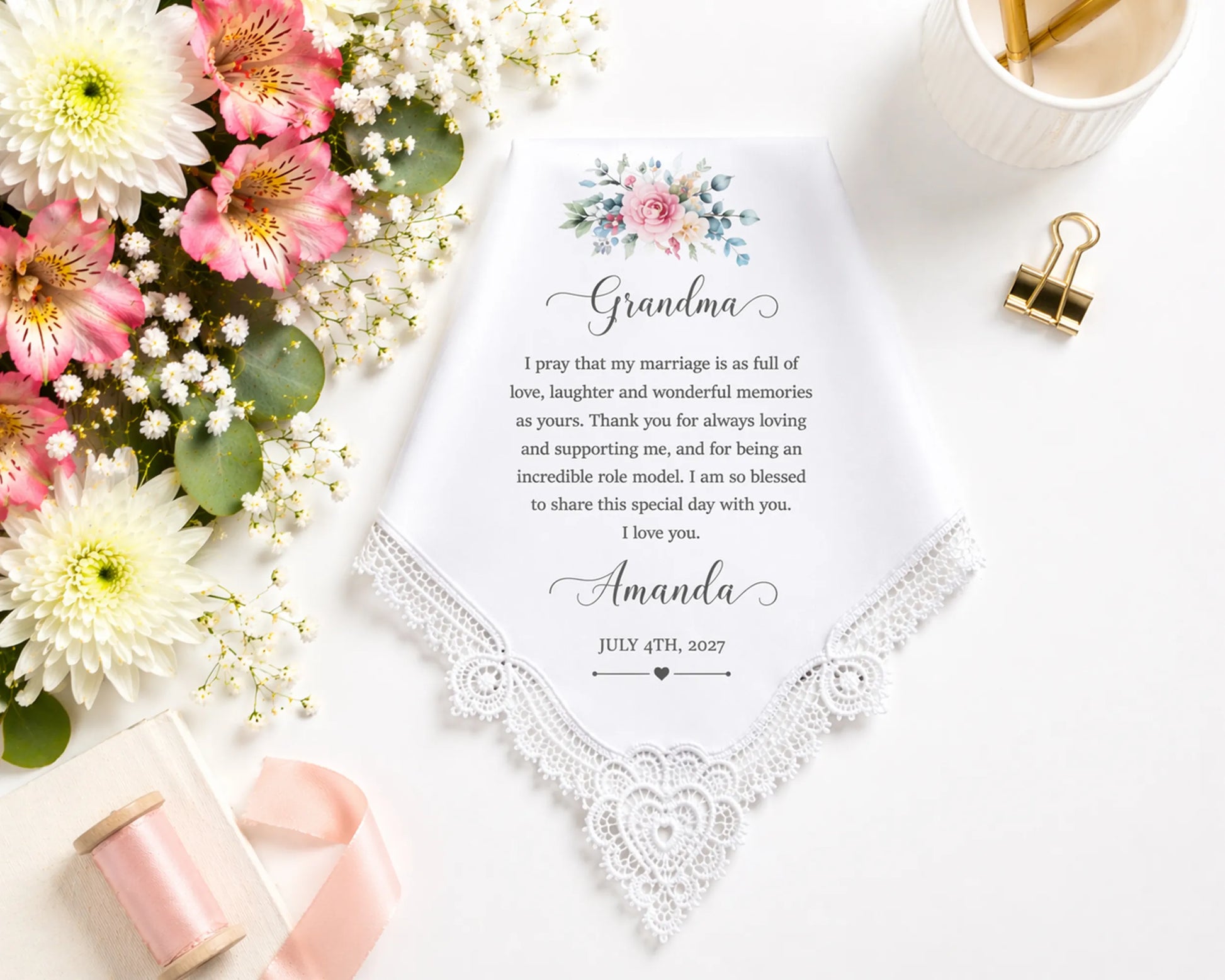 Letter to Grandma with flowers and stationery on a white surface