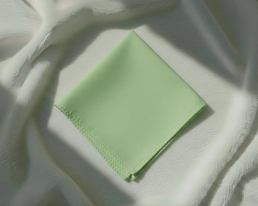 Green fabric on a textured white surface