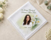 Memorial handkerchief with a photo of a woman and floral design on a beige background