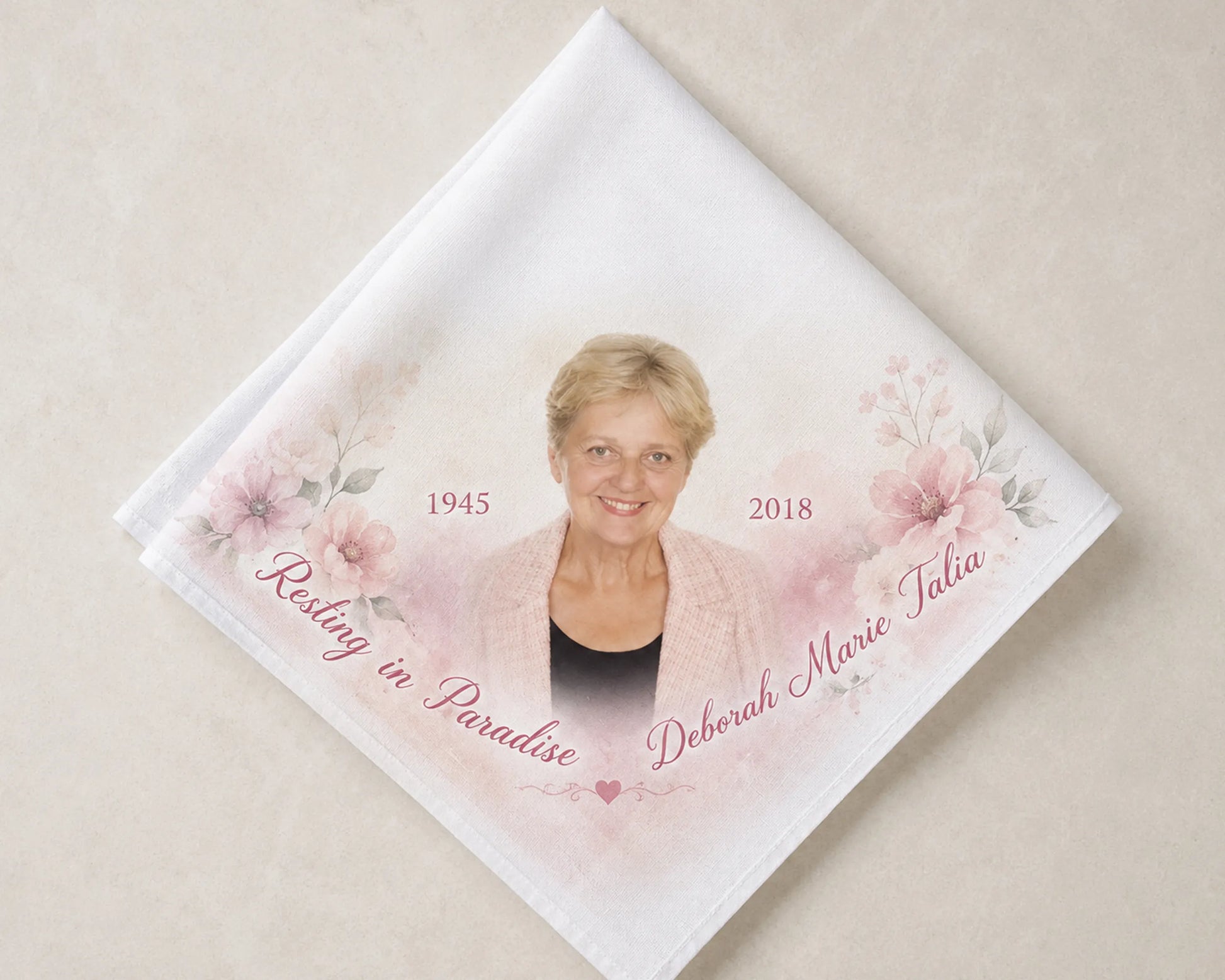 Memorial hanky with a photo of a woman, floral design, and text on a beige background