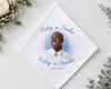 Memorial hnaky with a photo of a man and 'Resting in Paradise' text on a white background with flowers.