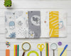 Row of children’s cotton handkerchiefs featuring modern gray and yellow animal patterns