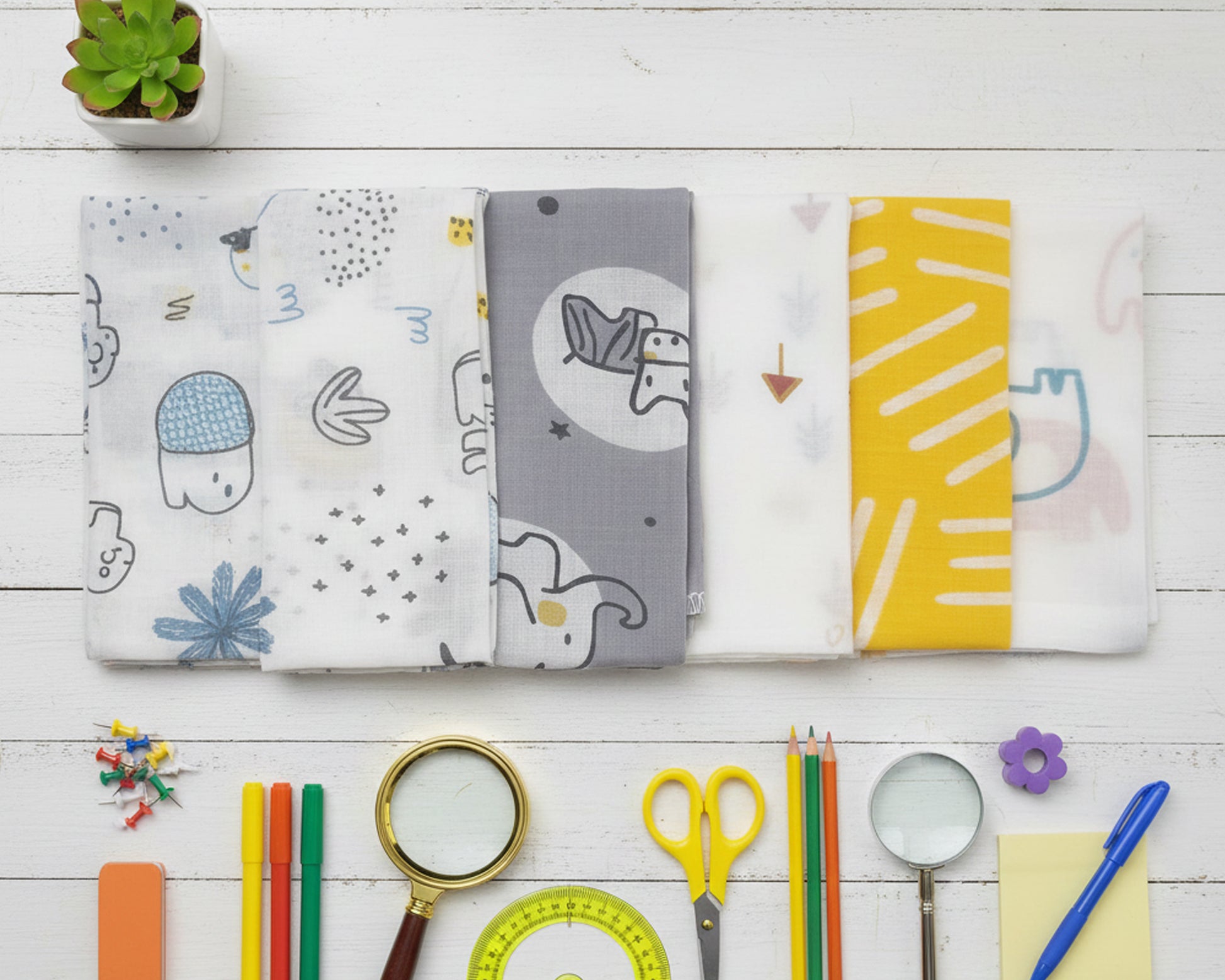 Row of children’s cotton handkerchiefs featuring modern gray and yellow animal patterns