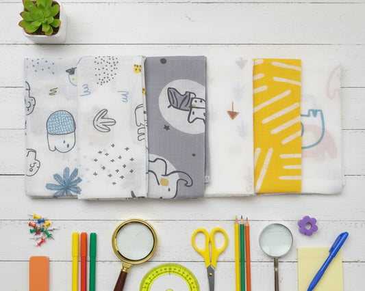 Row of children’s cotton handkerchiefs featuring modern gray and yellow animal patterns