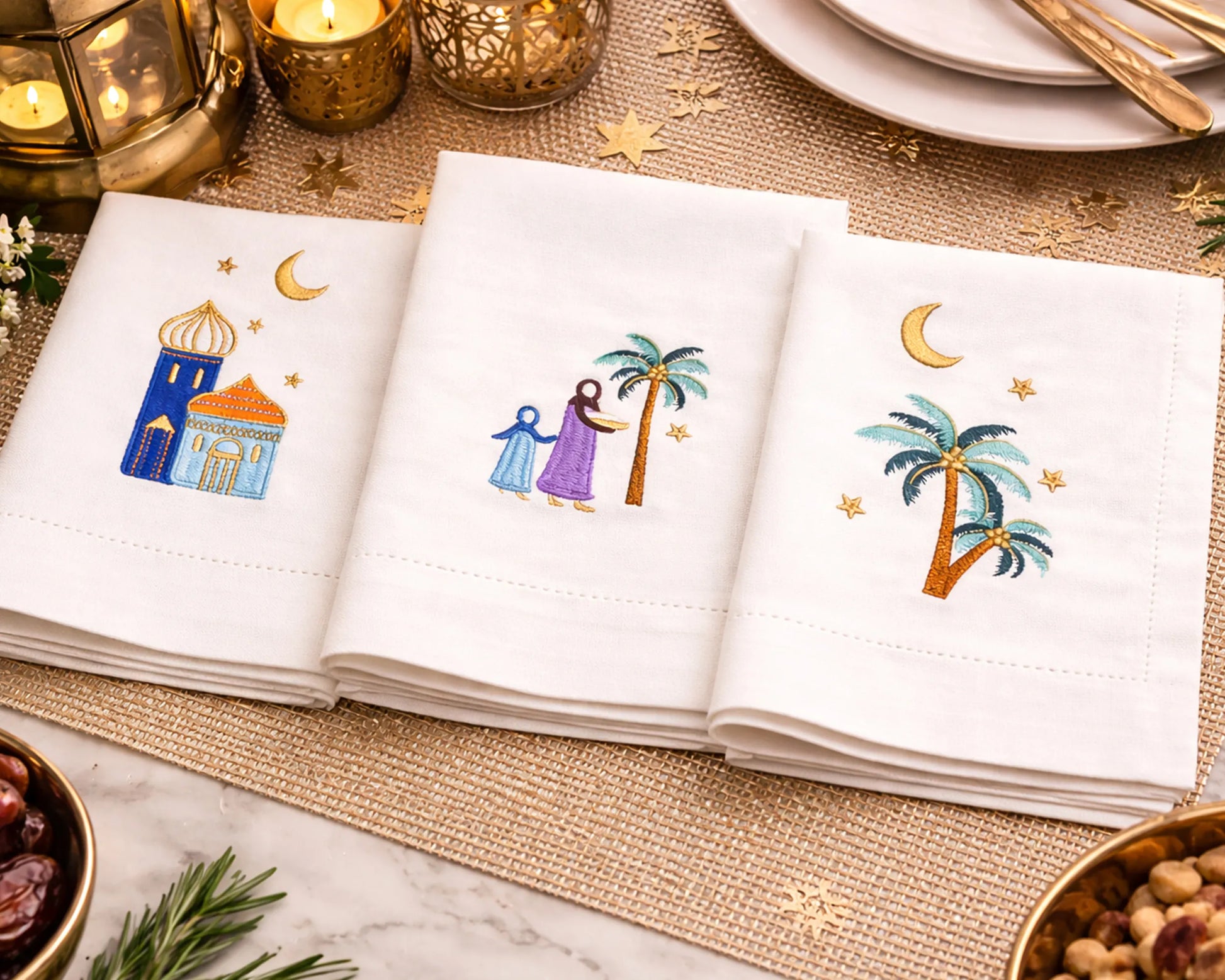 Napkins with embroidered designs of palm trees, stars, and buildings on a decorative table setting.