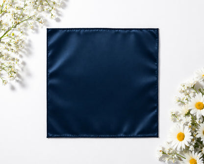 Navy blue fabric square surrounded by white flowers on a light background