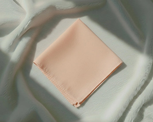 Light pink fabric square on a textured light green background