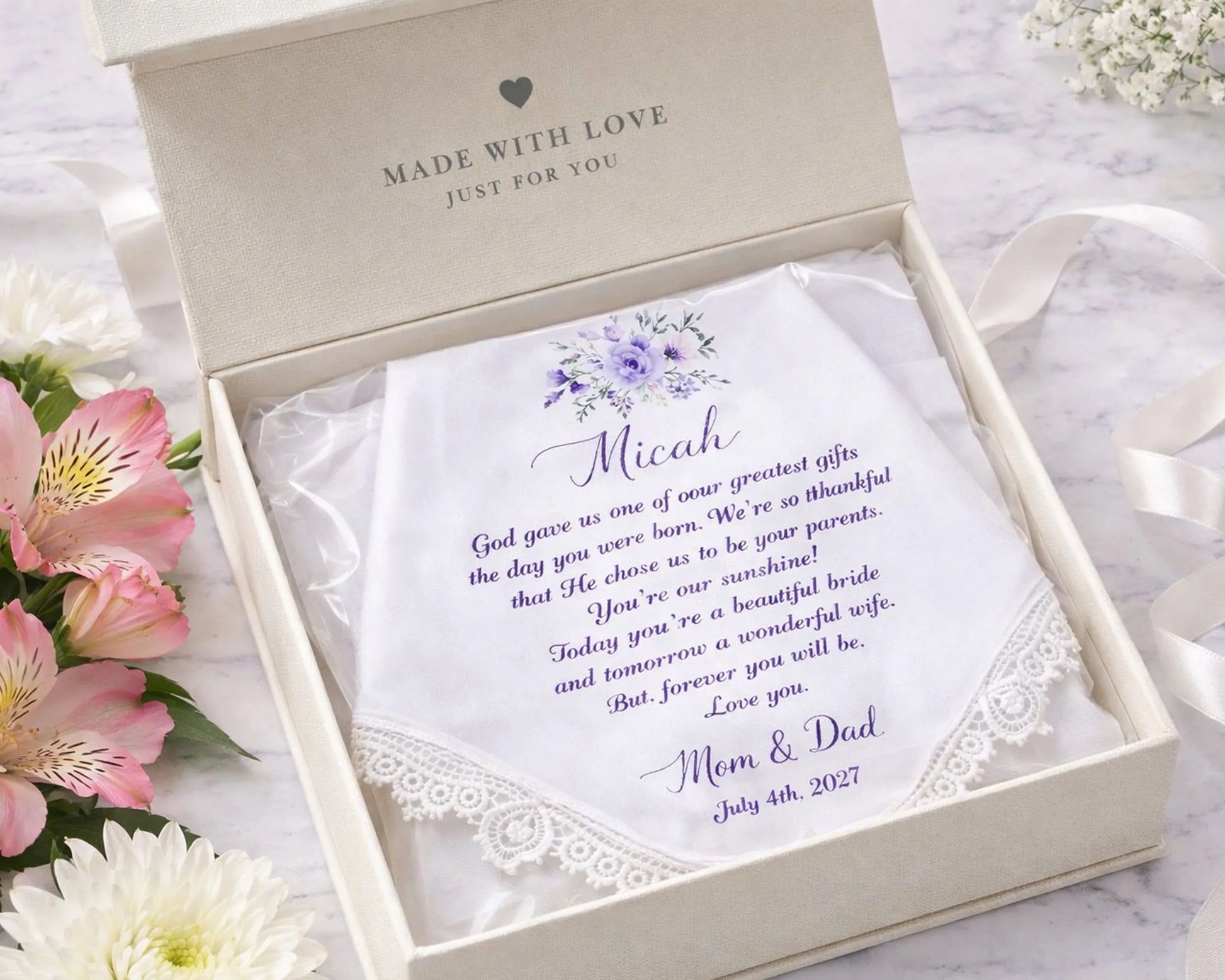 Personalized handkerchief in a decorative box with floral arrangement