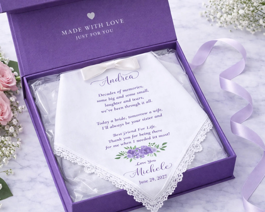 Personalized handkerchief in a purple box with a message and name, surrounded by flowers.