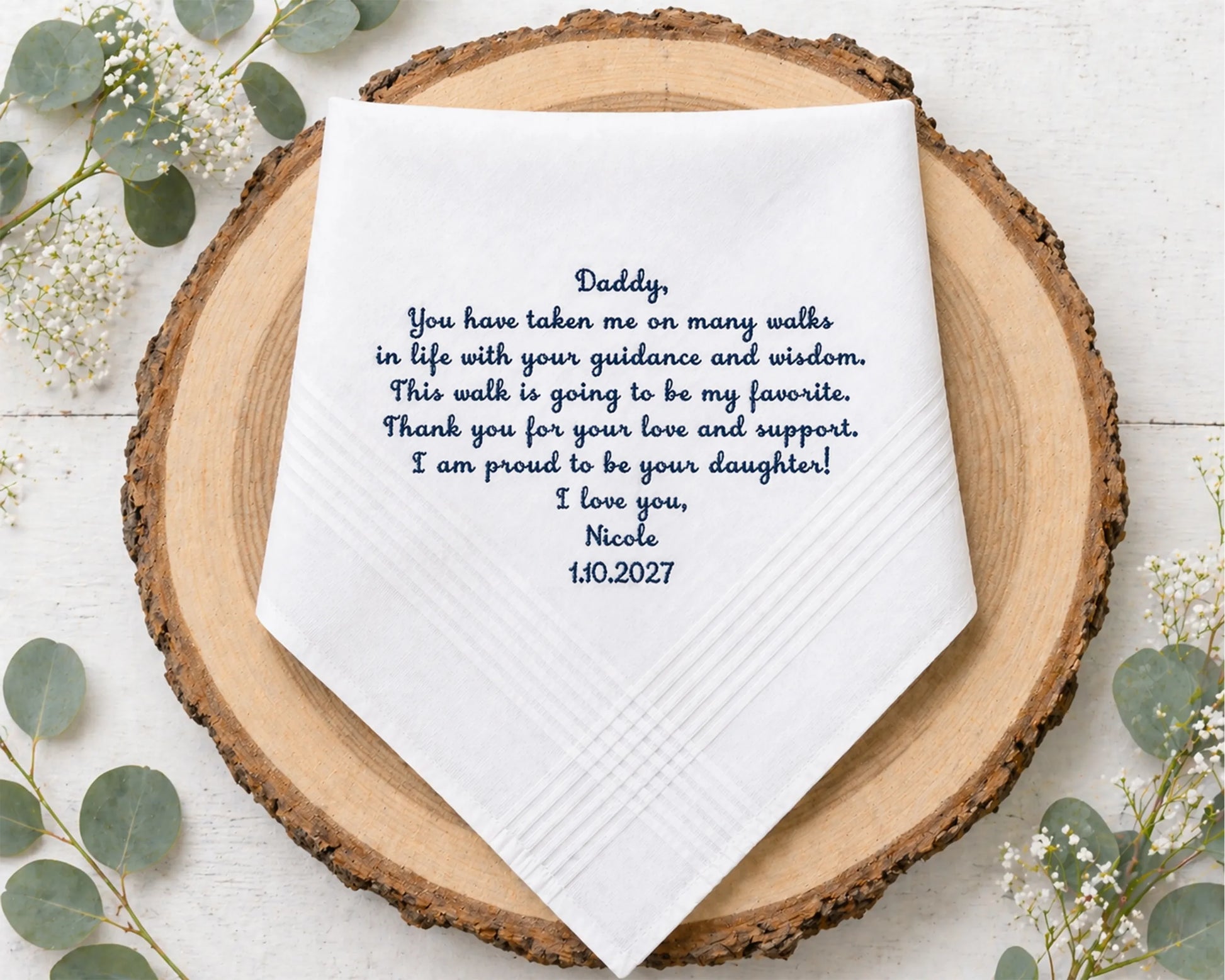 Personalized handkerchief with a message on a wooden plate surrounded by flowers