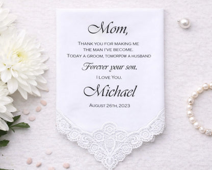 Personalized handkerchief with a message to 'Mom' on a white background with flowers and pearls.
