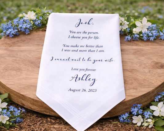 Personalized handkerchief with a romantic message on a wooden board surrounded by flowers