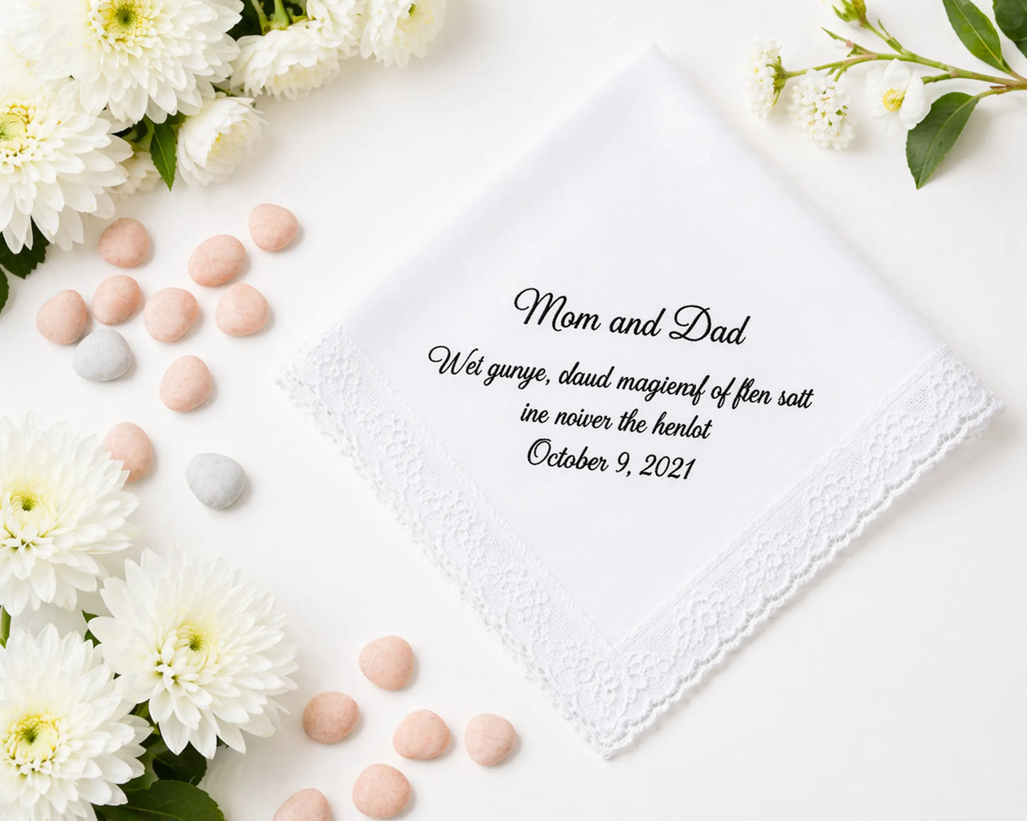 Personalized handkerchief with text print surrounded by flowers and candies on a white background