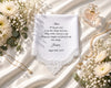 Personalized hanky with lace detailing, flowers, and jewelry on a white fabric background