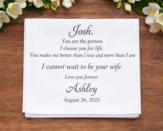 Personalized hanky with romantic message on a wooden surface with flowers