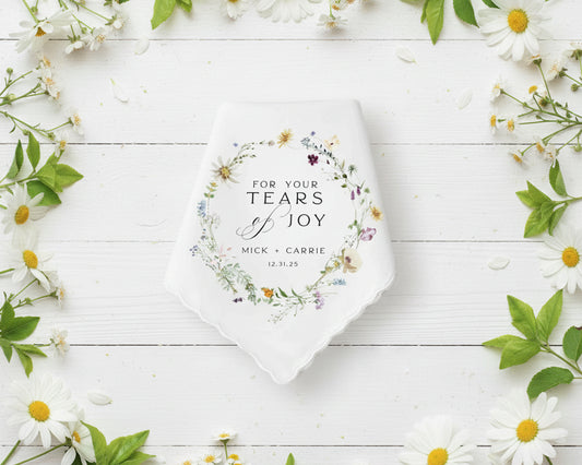 Personalized wedding favor with floral design and text on a white wooden background with flowers.