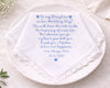 Personalized wedding handkerchief with embroidered message on a white plate.