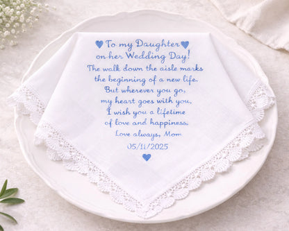 Personalized wedding handkerchief with embroidered message on a white plate.