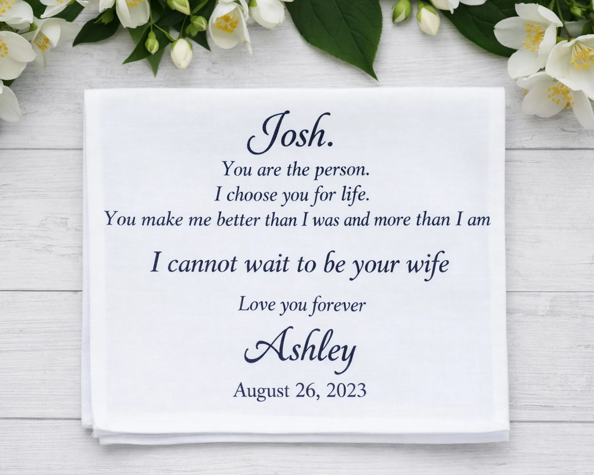Personalized wedding proposal hanky with floral decorations on a wooden surface
