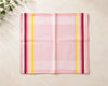 Pink hanky with colorful stripes on a beige surface