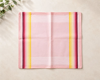 Pink hanky with colorful stripes on a beige surface