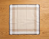 Plaid handkerchief on a wooden surface