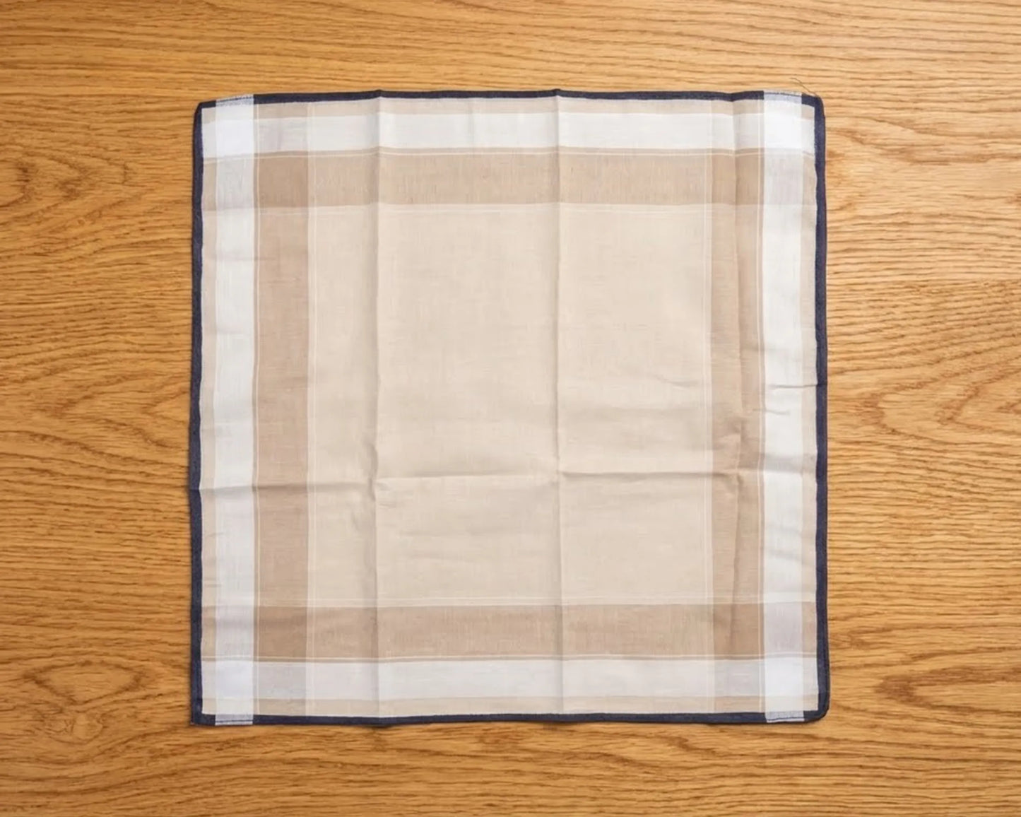 Plaid handkerchief on a wooden surface