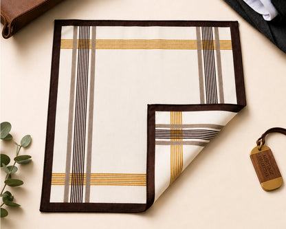 Plaid patterned product on a light surface with a plant and leather item in the background