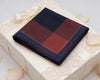 Plaid pocket square on a gift box with decorative elements