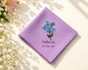 Purple hanky with floral embroidery and text on a light background