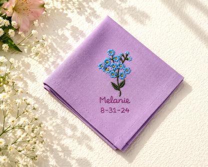 Purple hanky with floral embroidery and text on a light background