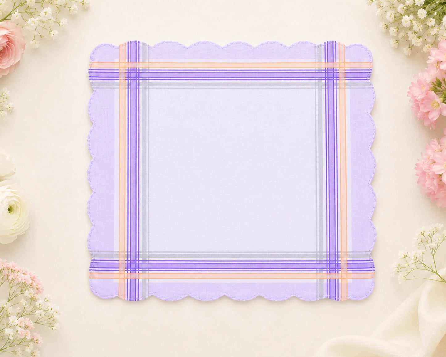 Purple plaid hanky with scalloped edges on a light background with flowers