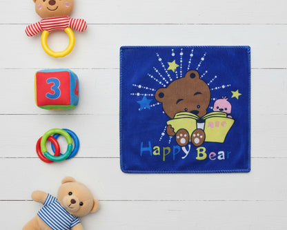 Dark blue children’s handkerchief featuring a bear reading an abc book with stars