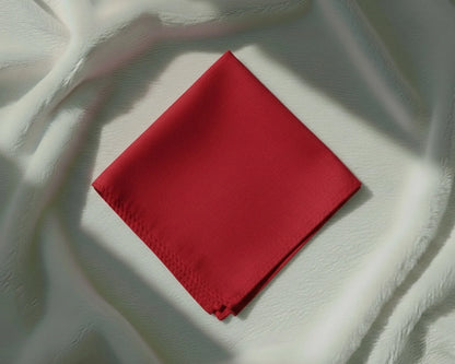 Red fabric square on a textured white background