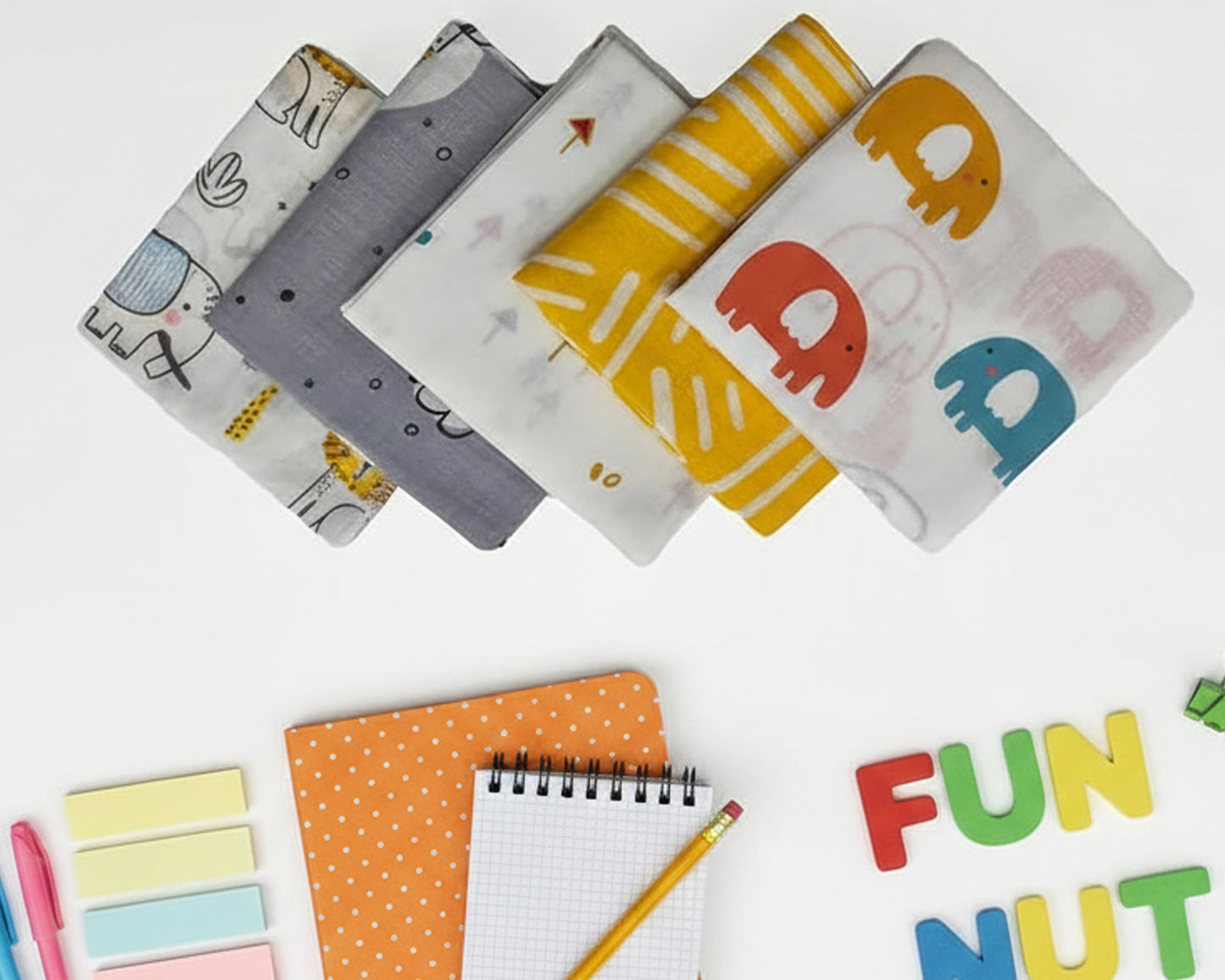 White kids cotton handkerchief with yellow elephant and lion illustrations made in the usa