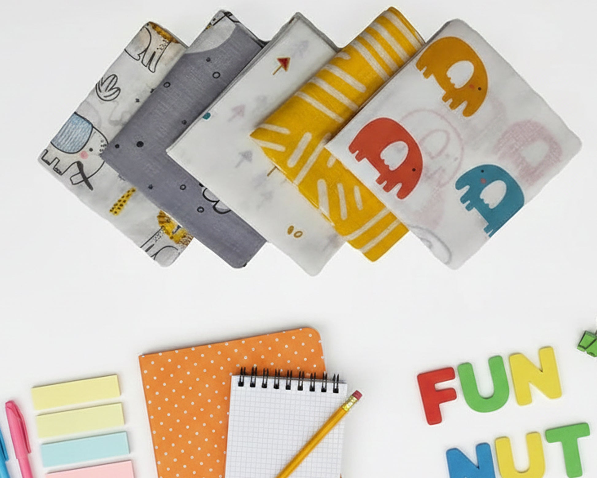 White kids cotton handkerchief with yellow elephant and lion illustrations made in the usa