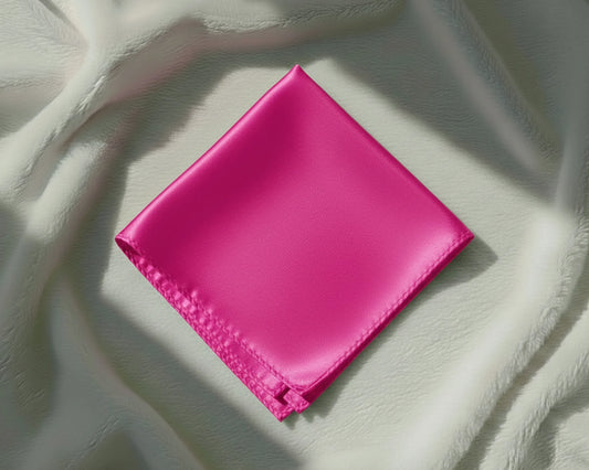 Pink fabric square on a textured white surface