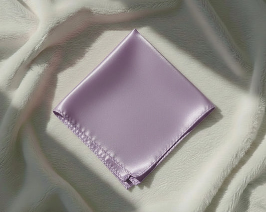 Folded purple fabric on a textured light green surface