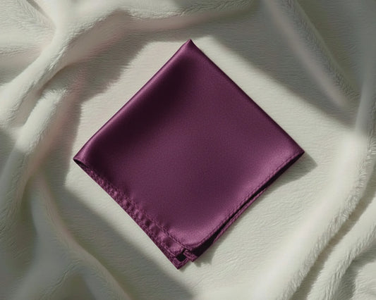 Folded purple fabric on a textured white surface