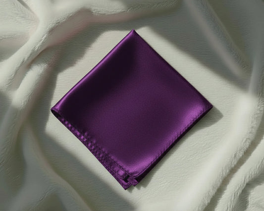 Purple fabric square on a textured white surface