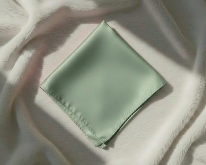 Green fabric square on a textured white surface