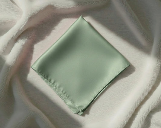 Green fabric square on a textured white surface